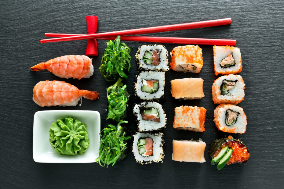 Set of sushi with wasabi and chopsticks on slate